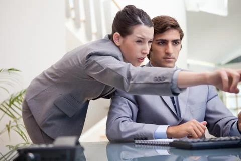 Businesswoman explaining computer program to colleague 스톡 사진