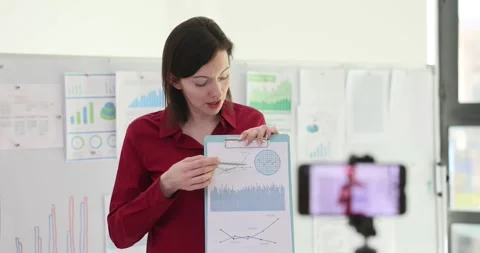 Businesswoman explaining graphs and data charts during presentation in office Stock Footage 285591807