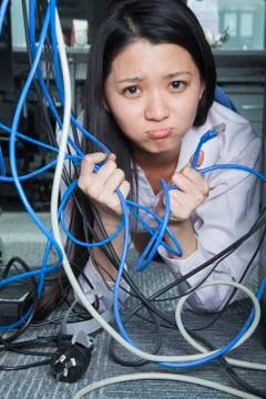 Businesswoman Frustrated by Ethernet Cord Stock Photos