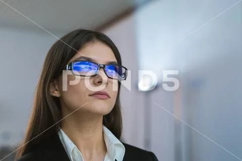 The businesswoman with glasses against the background of the projector Stock Photos
