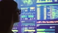 The businesswoman in glasses looking to the big display 4k or 4k+ Resolution