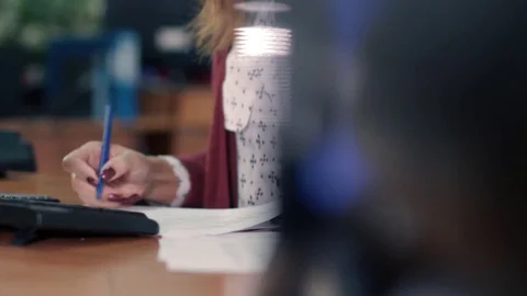 Businesswoman hands making notes in documents sitting in the workplace Stock Footage 82134736