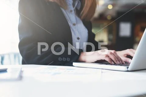 Businesswoman hands typing on laptop keyboard. Stock Photos