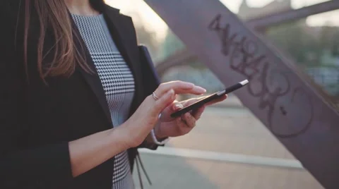 Businesswoman Hands Using SmartPhone in Sunny City. SLOW MOTION. STEADICAM Stock Footage