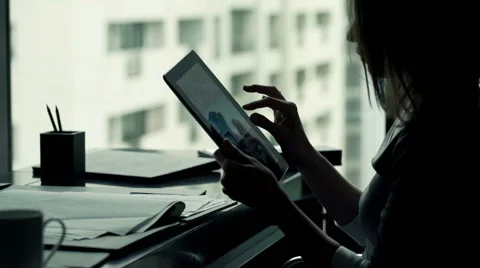 Businesswoman hands using tablet computer while sitting by desk in office Stock Footage 54695863