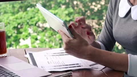 Businesswoman hands using tablet computer while sitting by table on terrace Stock-Footage 105433973