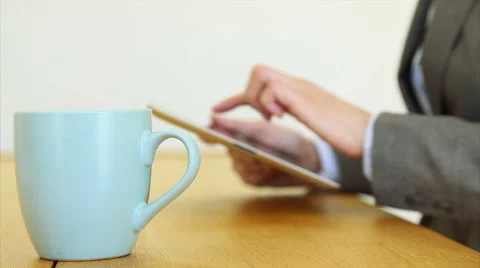 Businesswoman having coffee while using digital tablet Stock Footage 53481768
