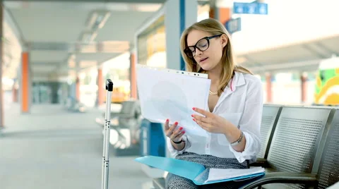 Businesswoman having a painful headache while sitting on the train station Stock Footage