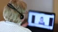 Businesswoman with headphones and notebook speaks with customer HD Footage