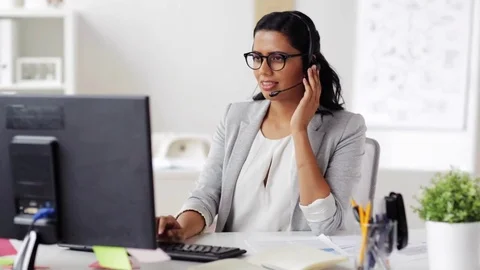 Businesswoman with headset and computer at office Stock Footage