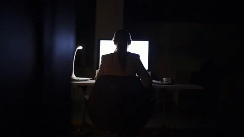 Businesswoman in her office at night working late. Stock Footage