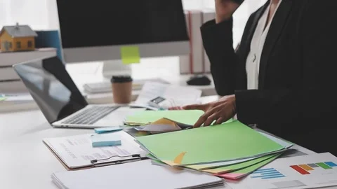 Businesswoman holding document working at laptop pc computer doing online t.. Video stock 345789341