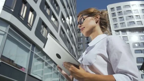 Businesswoman Holding Tablet near Corporation Building Stock Footage