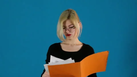 Businesswoman holds folder with documents checking data Stock Footage 275356580
