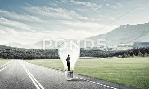 Businesswoman inside light bulb Stock Photos