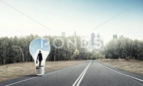 Businesswoman inside light bulb Stock Photos