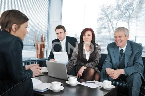 Businesswoman in an interview with three business people getting positive fee Stock Photos
