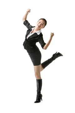 Businesswoman jumping in studio Stock Photos