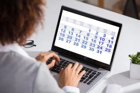 Businesswoman Looking At Calendar With Daily Agenda Stock Photos