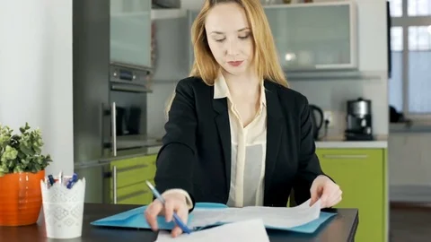Businesswoman looks busy while working on documents, steadycam shot Stock Footage