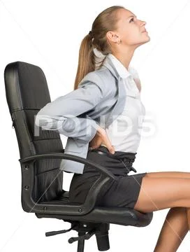 Businesswoman with lower back pain from sitting on office chair Stock Photos