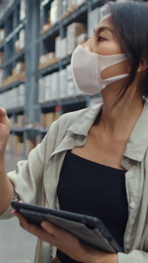 Businesswoman manager looking for goods using digital tablet check inventory. Stock Footage 336003853