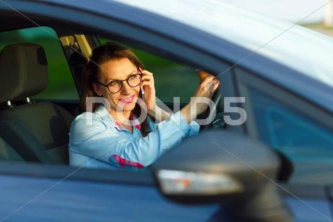 Businesswoman multitasking while driving Stock Photos