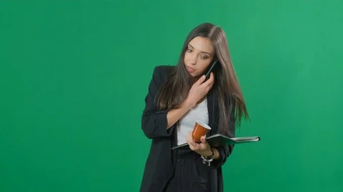 Businesswoman multitasking while working with documents, drinking coffee and Stock Footage 120094253