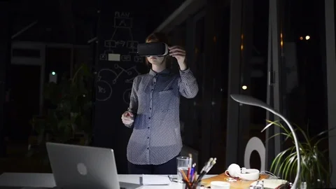 Businesswoman in the office wearing virtual reality goggles. Stock Footage