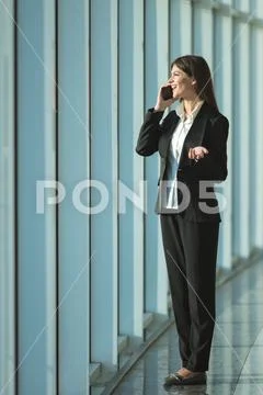 The businesswoman phone near the panoramic window Stock Photos