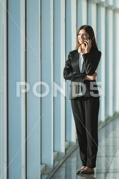 The businesswoman phone near the panoramic window Stock Photos