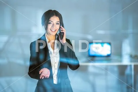 The businesswoman phone near the window Stock Photos