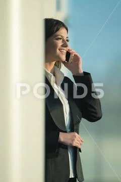 The businesswoman phone over the column Stock Photos