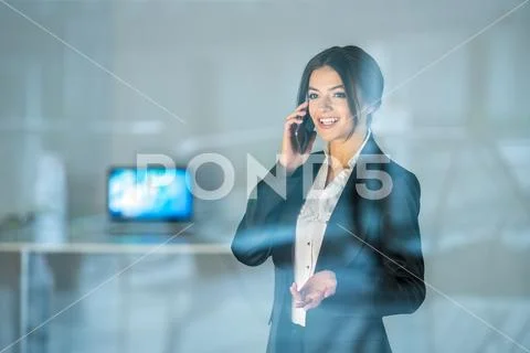 The businesswoman phone over the window Stock Photos