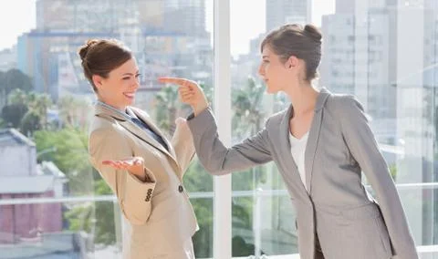 Businesswoman pointing at her rival Stock Photos
