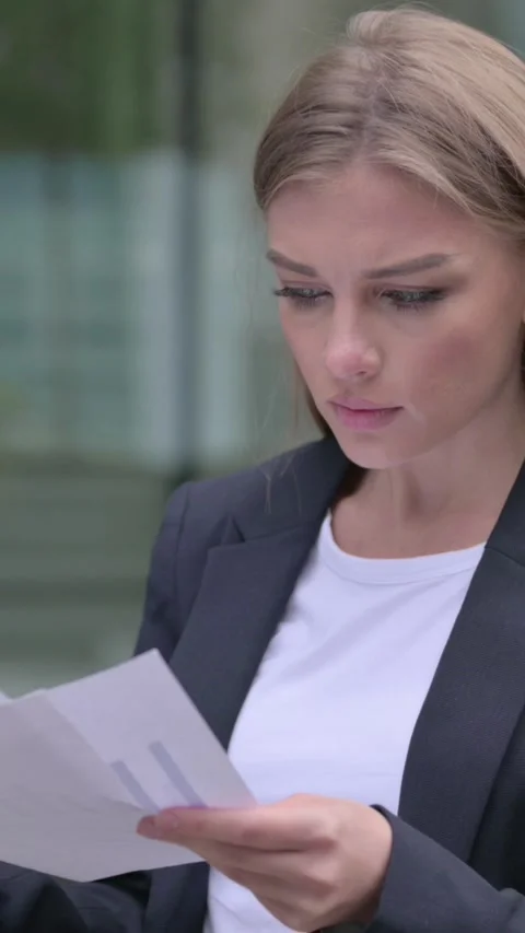 Businesswoman Reading Documents while Standing in Street, Vertical Video Stock Footage 340028675