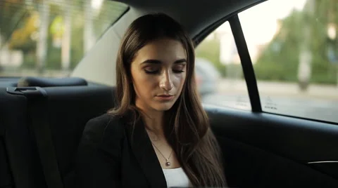 Businesswoman riding in a taxi to a business meeting, making a plan of Stock Footage