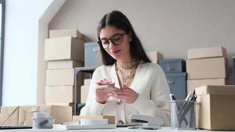 Businesswoman Scanning Barcode On Parcel Preparing To Send Or Conducting Audit Stock Footage 266155247