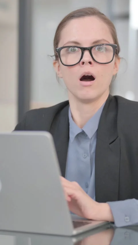 Businesswoman Shocked at Camera while at Work, vertical video Stock Footage 325566224