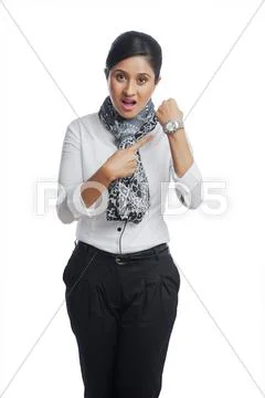 Businesswoman shouting and pointing toward a wristwatch Stock Photos