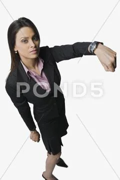 Businesswoman showing a wristwatch Stock Photos