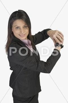 Businesswoman showing a wristwatch Stock Photos
