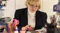 Businesswoman sits at the table in office among commercial papers HD Footage
