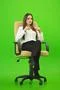 The businesswoman sitting on the green background Photo