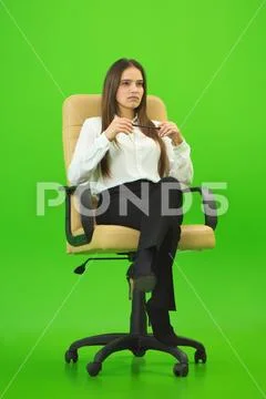 The businesswoman sitting on the green background Stock Photos