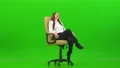 The businesswoman sitting on the office chair and laughing on a green background 4k or 4k+ Resolution