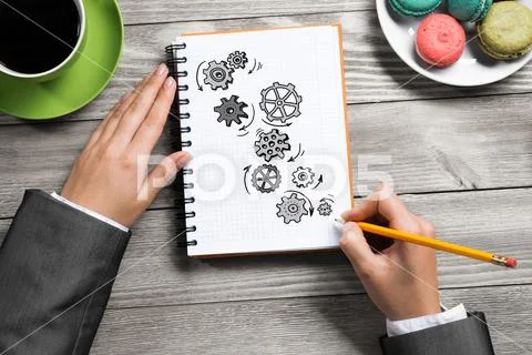 Businesswoman sketching in notepad Stock Photos