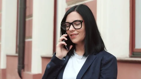 Businesswoman with smartphone close up. Girl speaks on cell phone. Beautiful Stock Footage
