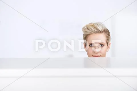 Businesswoman smiling in office cubicle Stock Photos