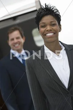 Businesswoman Standing With Colleague At Airfield Stock Photos